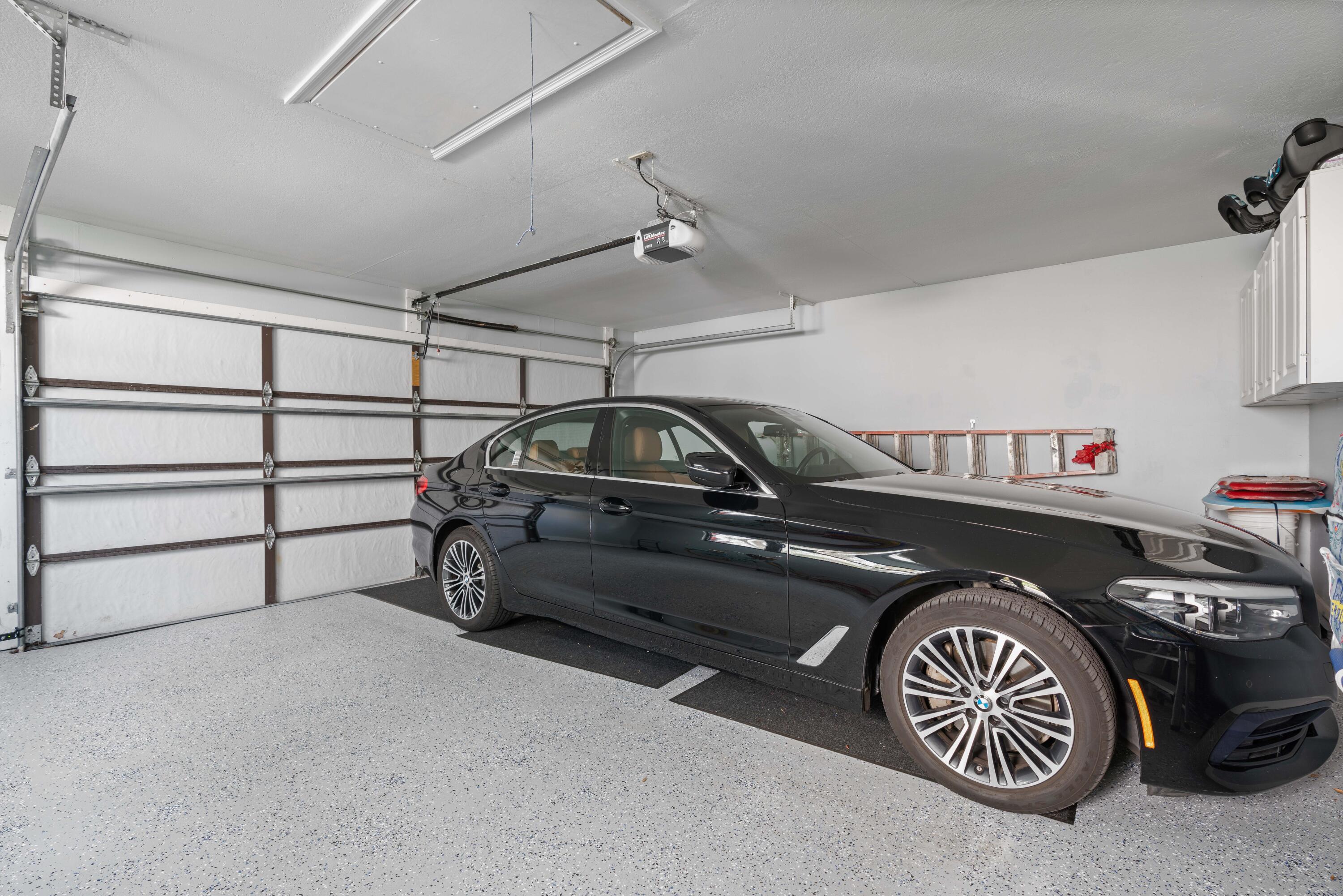 17023 Traverse Circle Jupiter, FL 33477 - Photo 27 of 35 a car parked in a garage