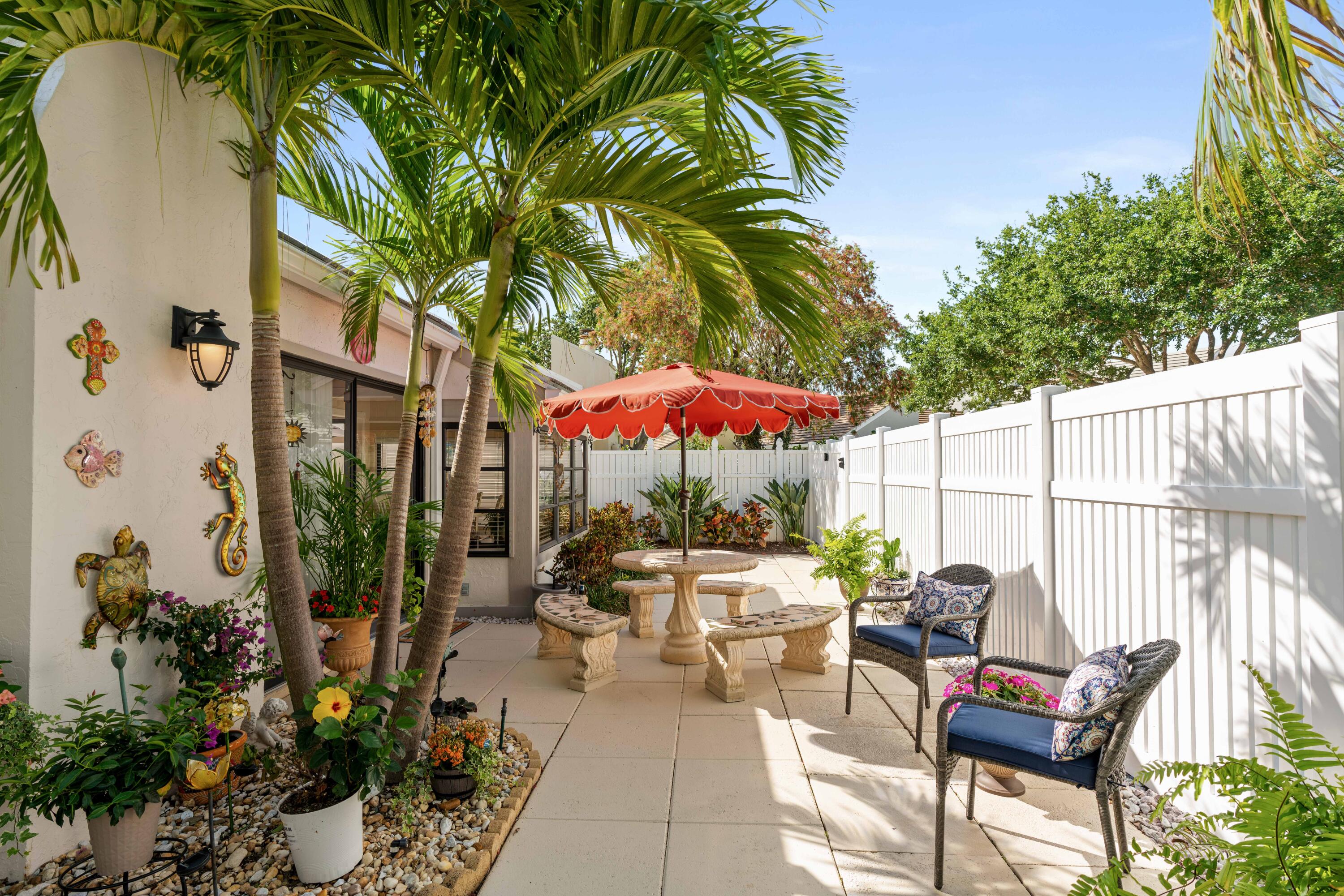 17023 Traverse Circle Jupiter, FL 33477 - Photo 29 of 35 an outdoor space with furniture and umbrella