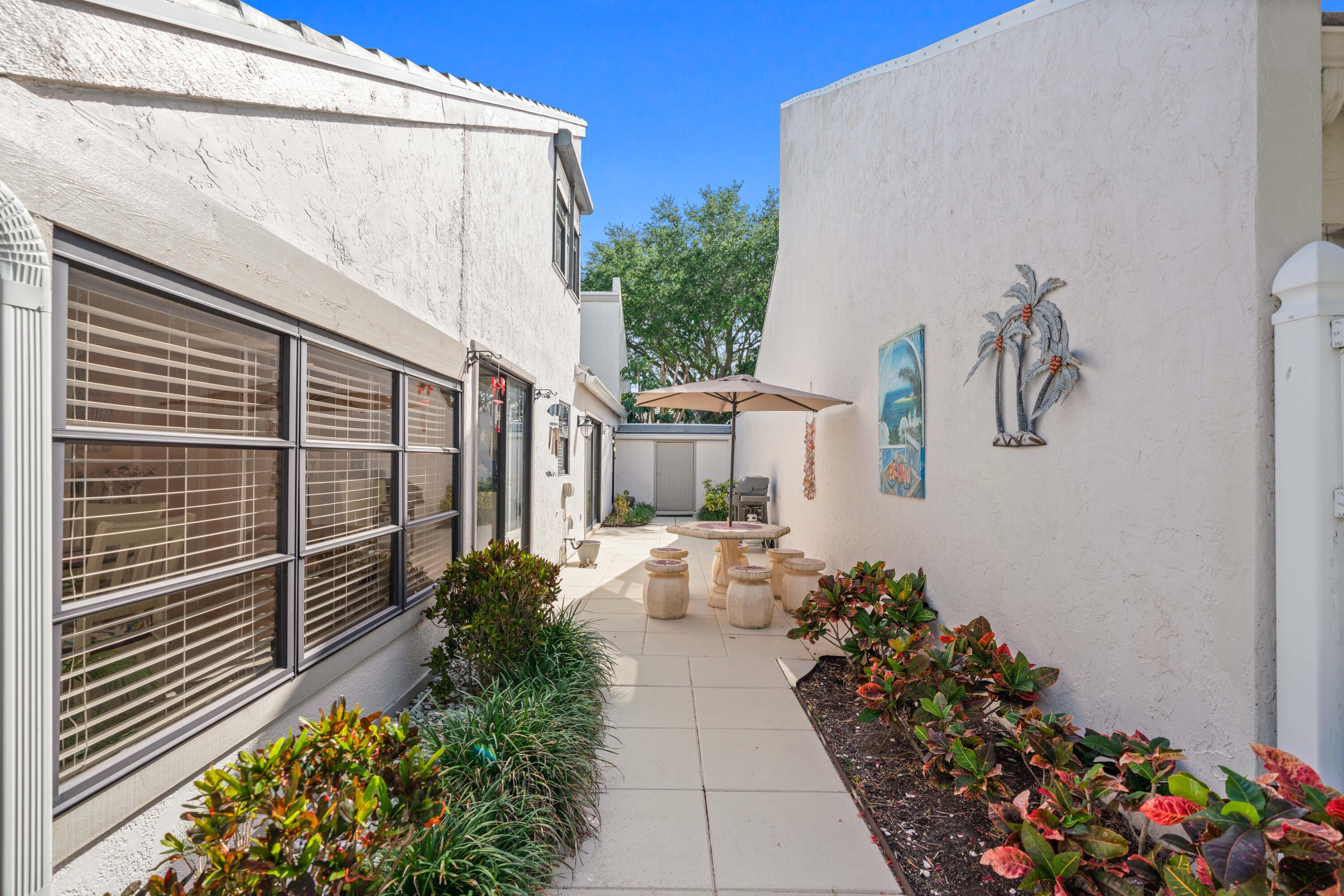 17023 Traverse Circle Jupiter, FL 33477 - Photo 34 of 35 a view of a pathway of house with flower pots