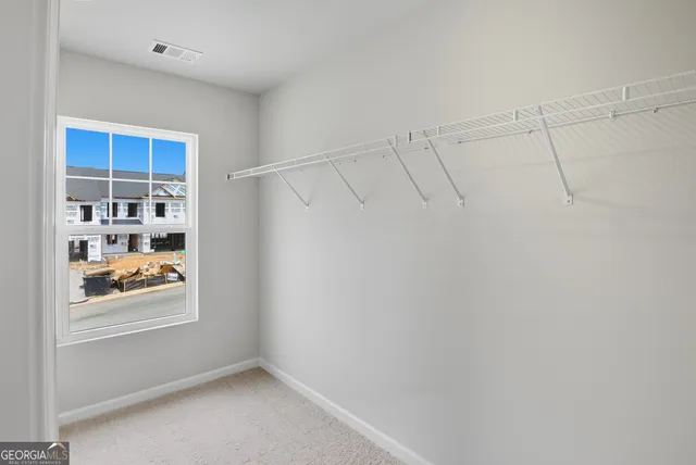 a view of storage and utility room with closet