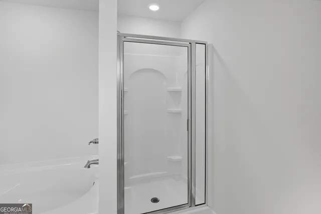 a bathroom with a glass shower door