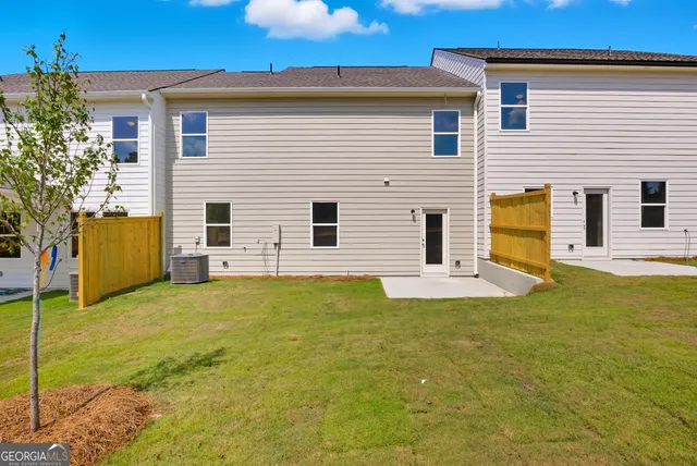 a view of a house with pool and a yard
