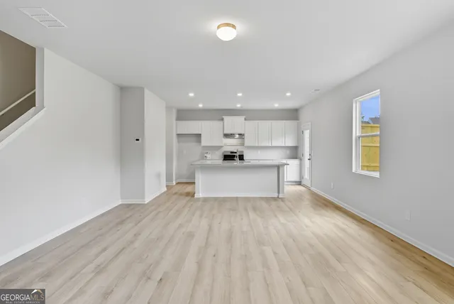 a view of kitchen with wooden floor and electronic appliances