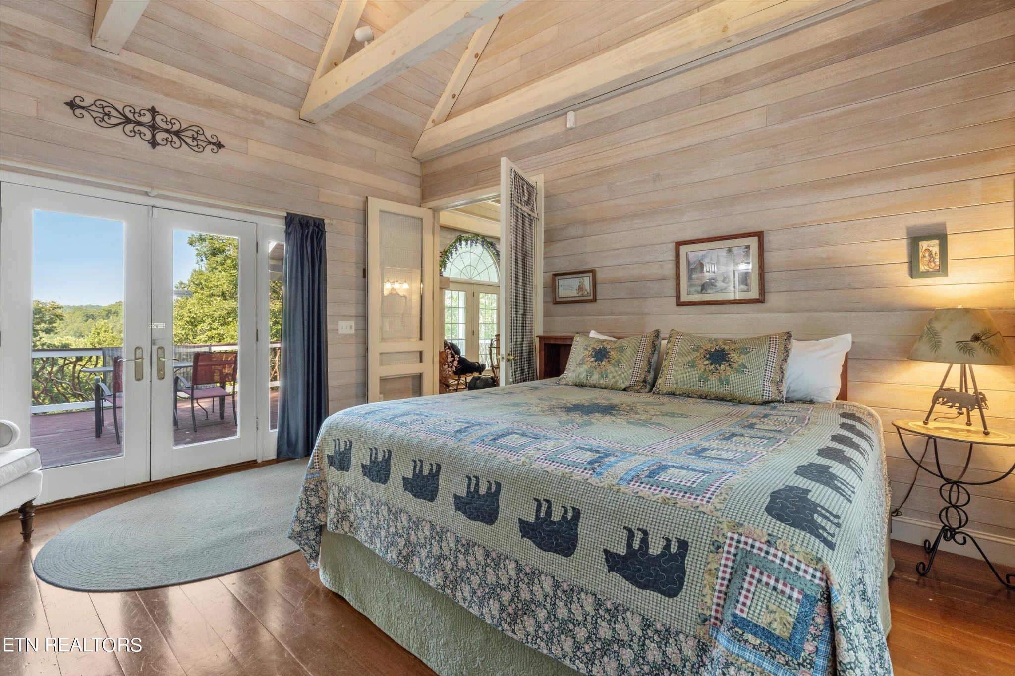 3638 Locust Ridge Road Sevierville, TN 37876 - Photo 25 of 50 a spacious bedroom with a bed a couch and large window with outer view