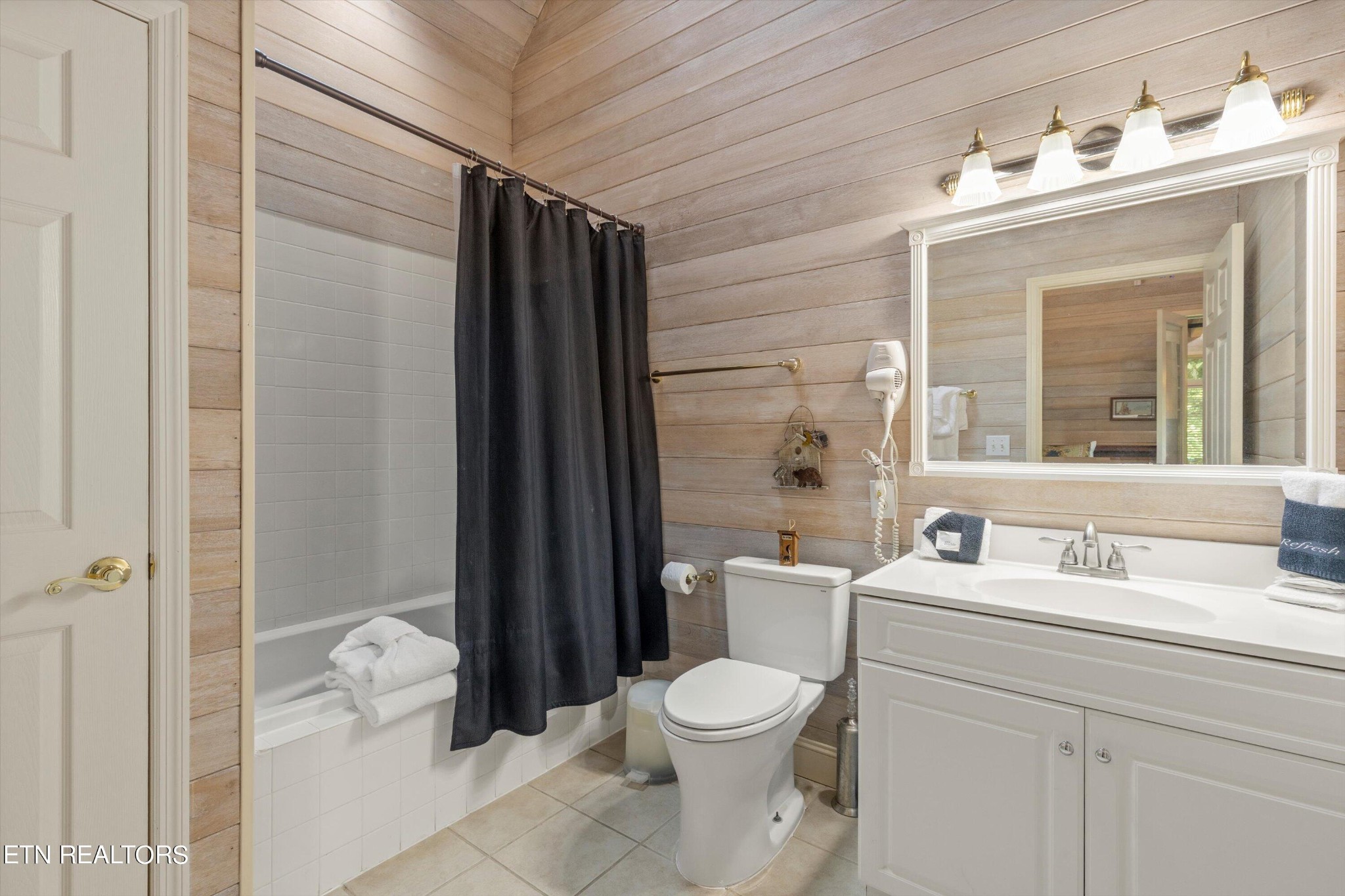 3638 Locust Ridge Road Sevierville, TN 37876 - Photo 27 of 50 a bathroom with a toilet sink vanity and mirror