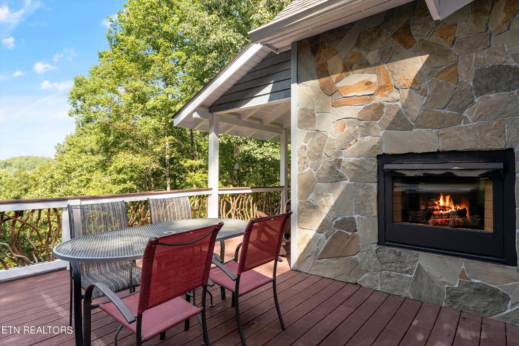 3638 Locust Ridge Road Sevierville, TN 37876 - Photo 35 of 50 a deck with a table and chairs with wooden floor