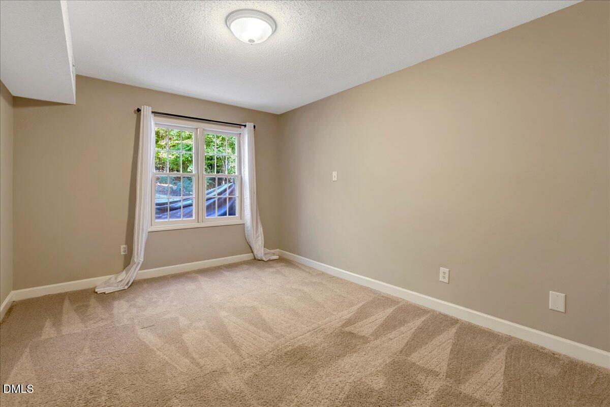 11808 Edgewater Court Raleigh, NC 27614 - Photo 28 of 56 an empty room with wooden floor and windows