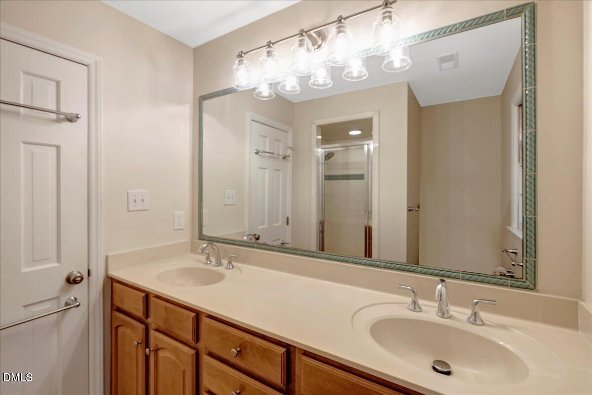 11808 Edgewater Court Raleigh, NC 27614 - Photo 33 of 56 a bathroom with a sink double vanity and a mirror