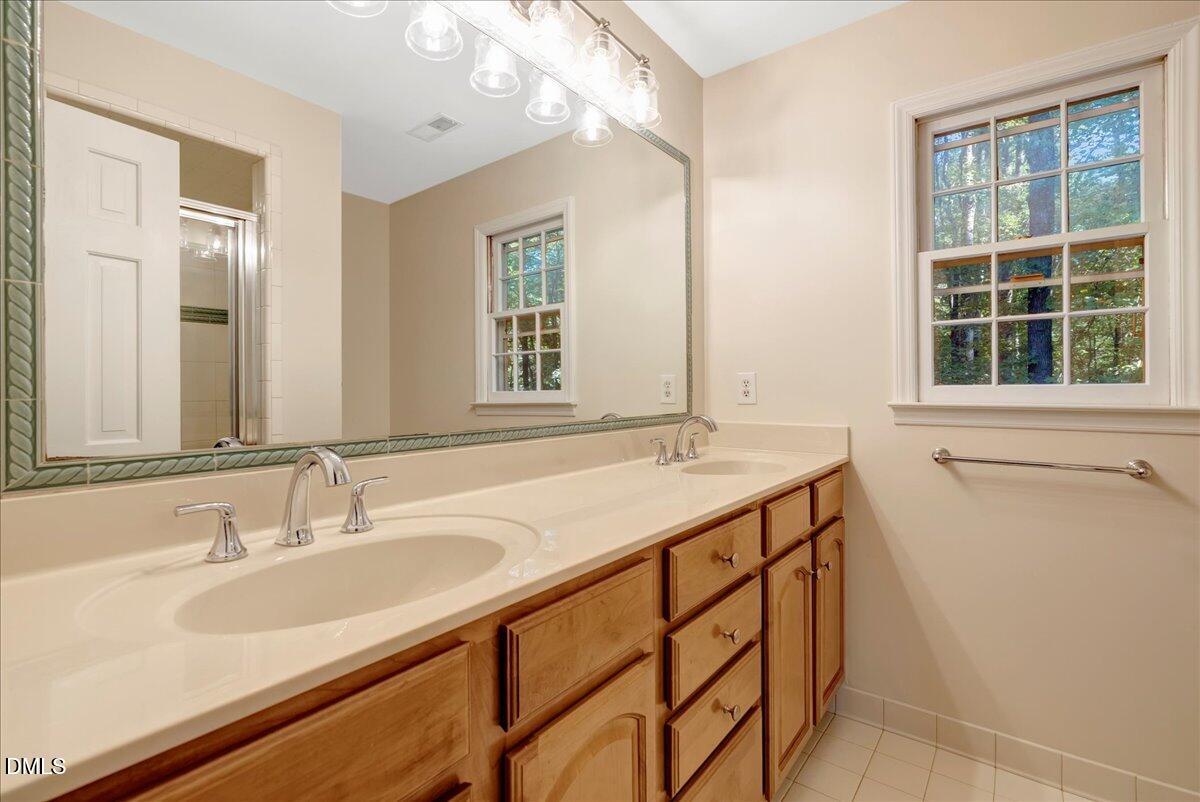 11808 Edgewater Court Raleigh, NC 27614 - Photo 42 of 56 a bathroom with a sink double vanity and a shower