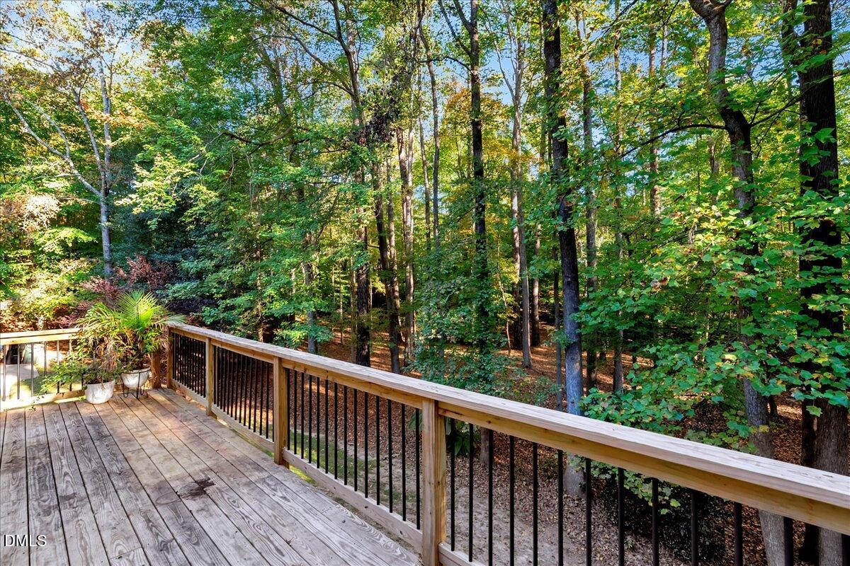 11808 Edgewater Court Raleigh, NC 27614 - Photo 44 of 56 a balcony with wooden floor and trees in the back