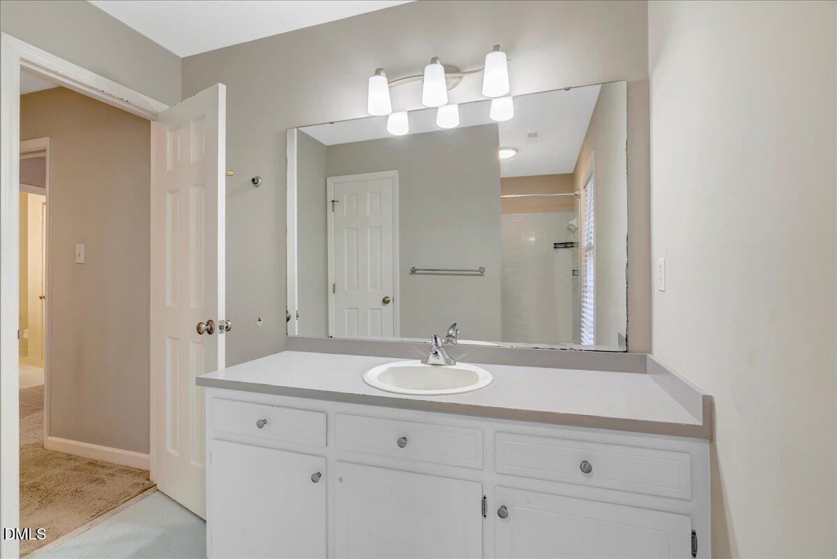 11808 Edgewater Court Raleigh, NC 27614 - Photo 47 of 56 a bathroom with a sink and a mirror