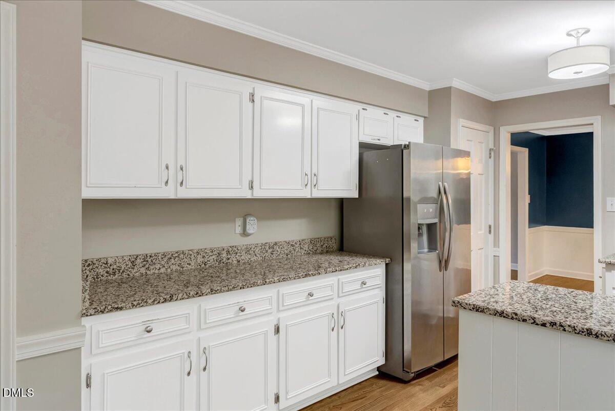 11808 Edgewater Court Raleigh, NC 27614 - Photo 49 of 56 a kitchen with granite countertop white cabinets and stainless steel appliances