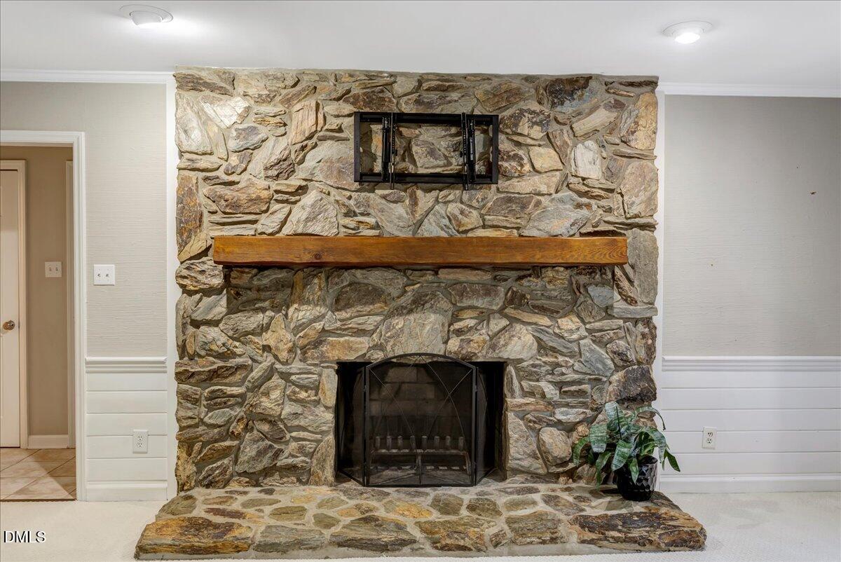11808 Edgewater Court Raleigh, NC 27614 - Photo 50 of 56 a stone fireplace with a clock on top of it