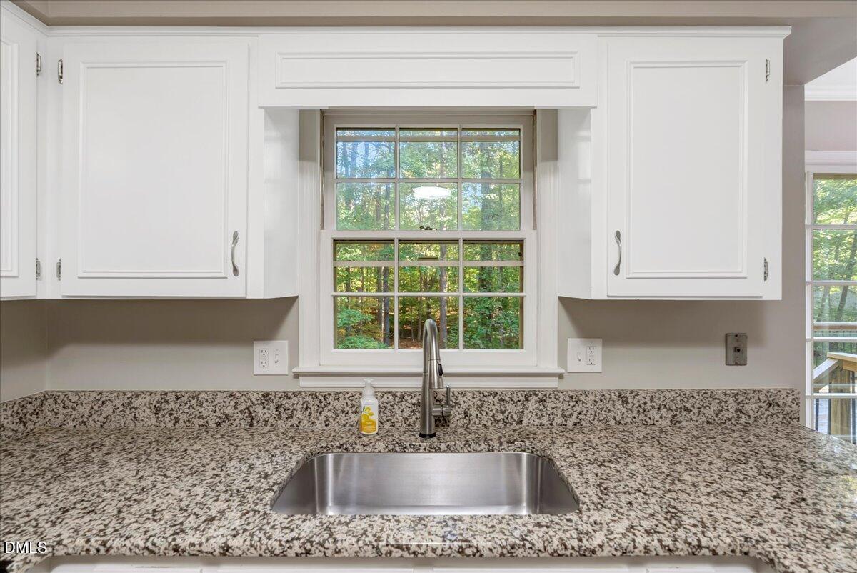 11808 Edgewater Court Raleigh, NC 27614 - Photo 55 of 56 a kitchen with granite countertop a sink and a window