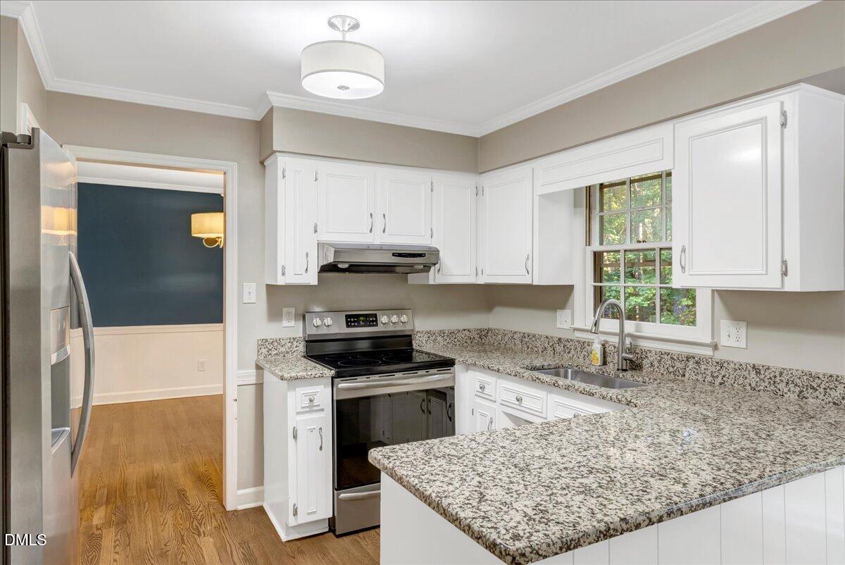 11808 Edgewater Court Raleigh, NC 27614 - Photo 56 of 56 a kitchen with a stove a sink and a refrigerator