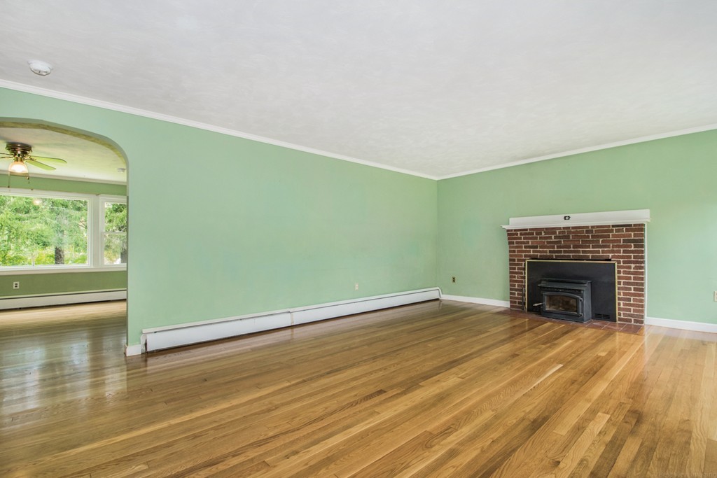 654 North Brookfield Road Oakham, MA 01068 - Photo 11 of 28 a view of empty room with wooden floor and fireplace