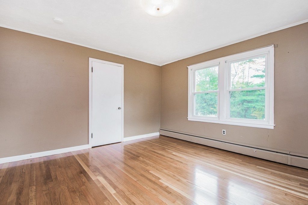 654 North Brookfield Road Oakham, MA 01068 - Photo 13 of 28 an empty room with wooden floor and windows