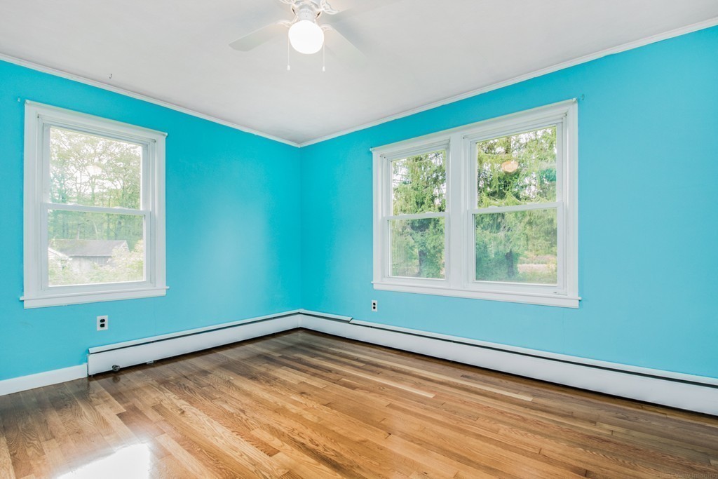 654 North Brookfield Road Oakham, MA 01068 - Photo 15 of 28 a view of an empty room with wooden floor and a window