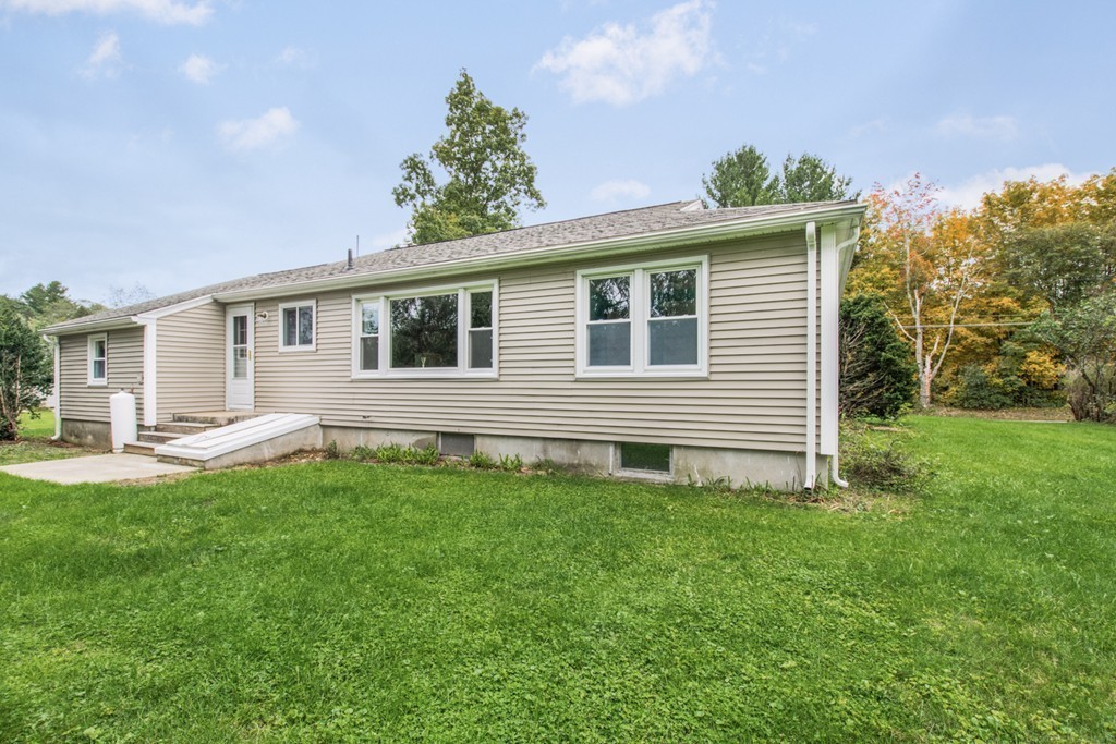 654 North Brookfield Road Oakham, MA 01068 - Photo 26 of 28 a backyard of a house with table and chairs