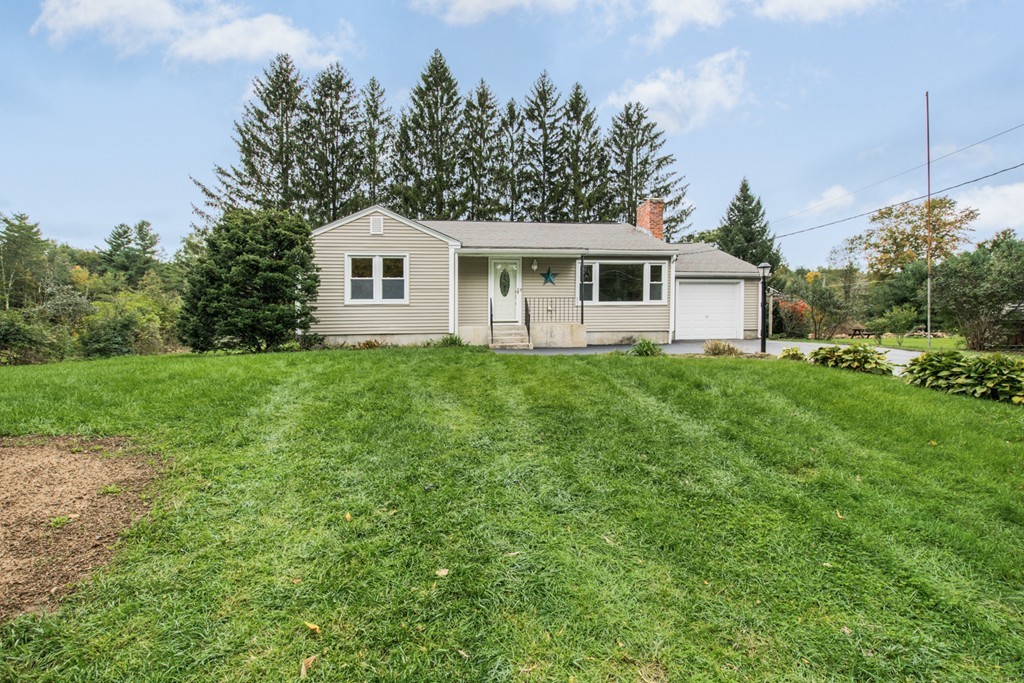 654 North Brookfield Road Oakham, MA 01068 - Photo 3 of 28 a front view of a house with a garden