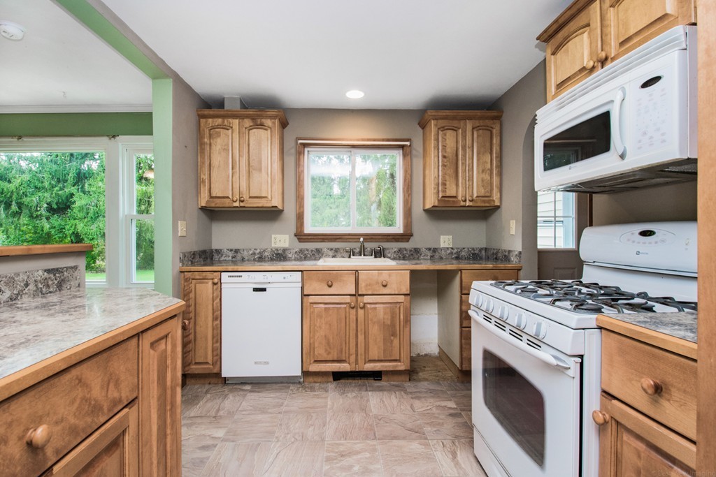 654 North Brookfield Road Oakham, MA 01068 - Photo 4 of 28 a kitchen with stainless steel appliances granite countertop a stove a sink and a microwave