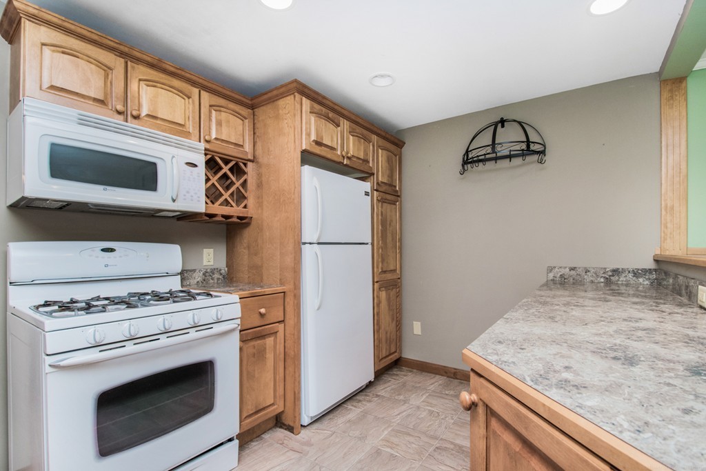 654 North Brookfield Road Oakham, MA 01068 - Photo 5 of 28 a kitchen with stainless steel appliances granite countertop a stove microwave and refrigerator