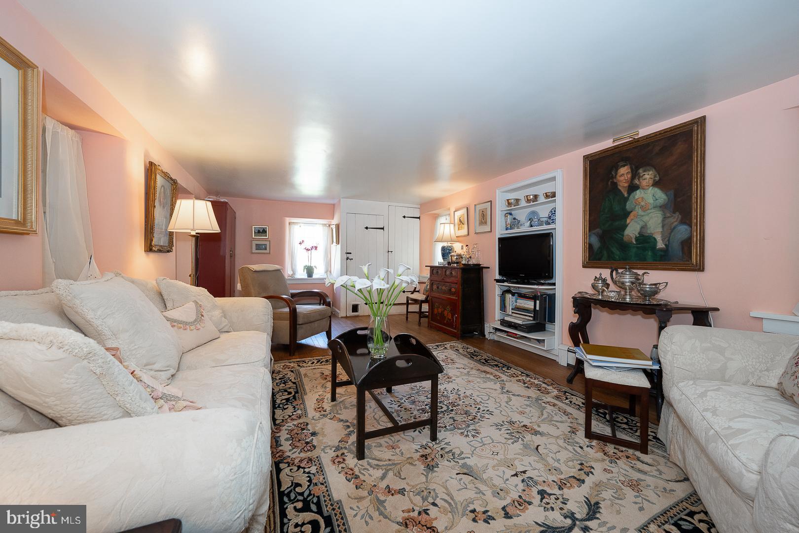 526 Egypt Road Phoenixville, PA 19460 - Photo 7 of 64 a living room with furniture a flat screen tv and a fireplace