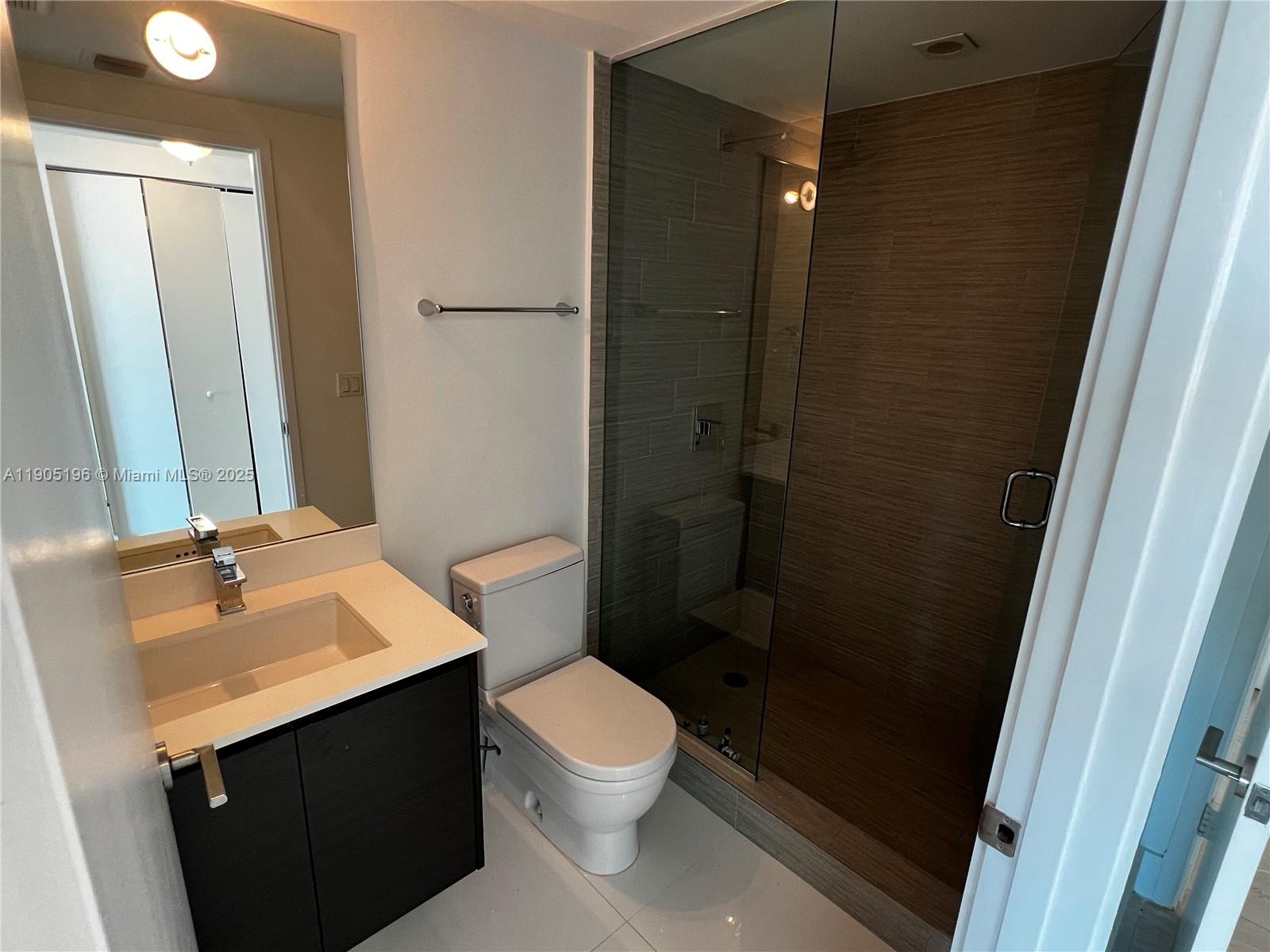 300 Sunny Isles Boulevard, Unit 4901 Sunny Isles Beach, FL 33160 - Photo 18 of 22 a bathroom with a sink and a mirror