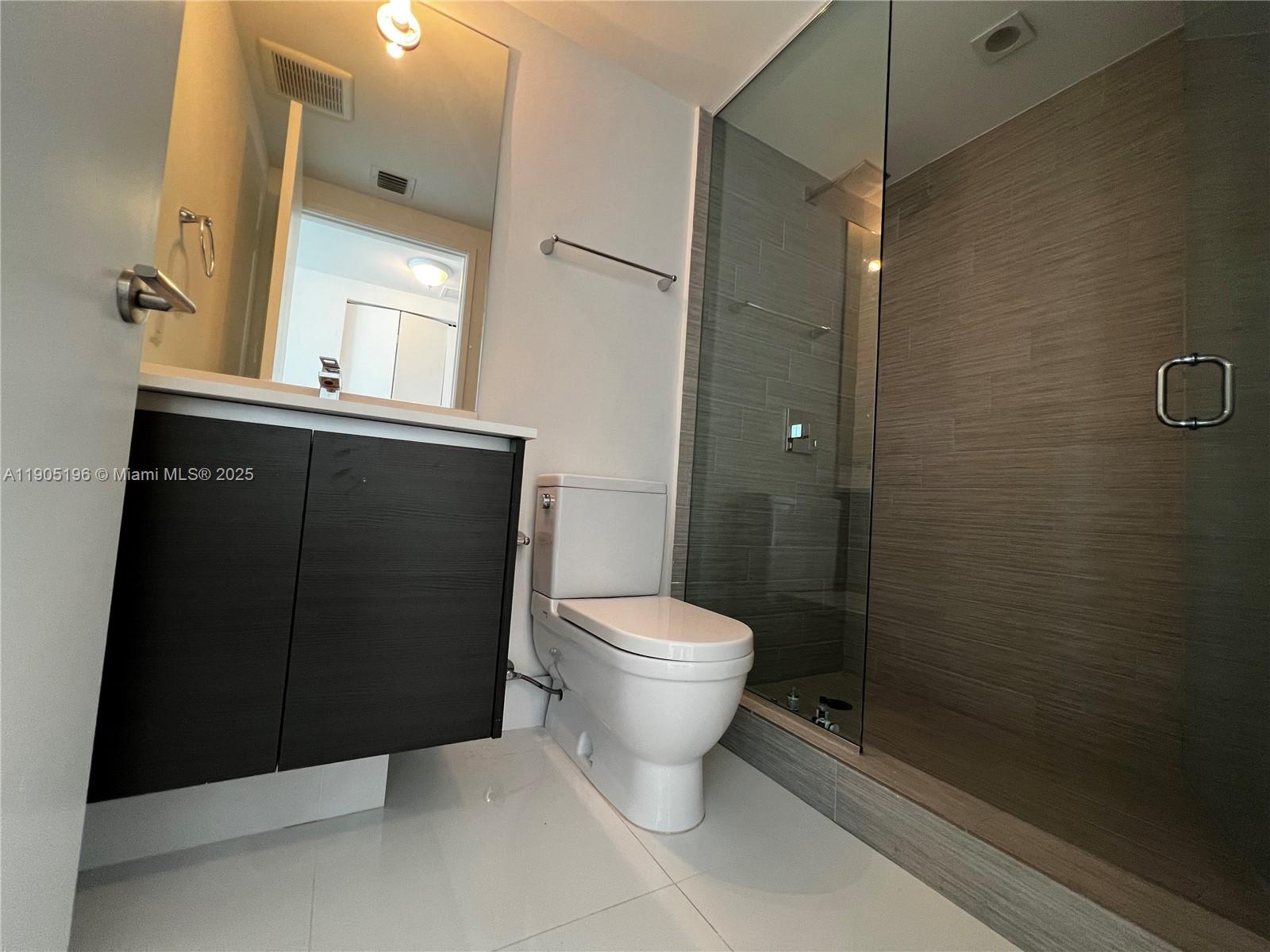 300 Sunny Isles Boulevard, Unit 4901 Sunny Isles Beach, FL 33160 - Photo 19 of 22 a bathroom with a sink toilet and shower