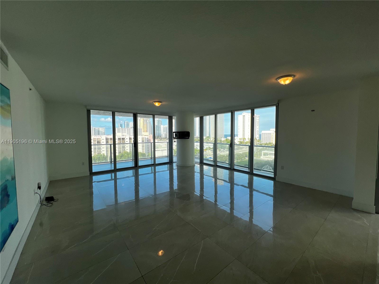 300 Sunny Isles Boulevard, Unit 4901 Sunny Isles Beach, FL 33160 - Photo 4 of 22 a view of empty room with floor to ceiling window