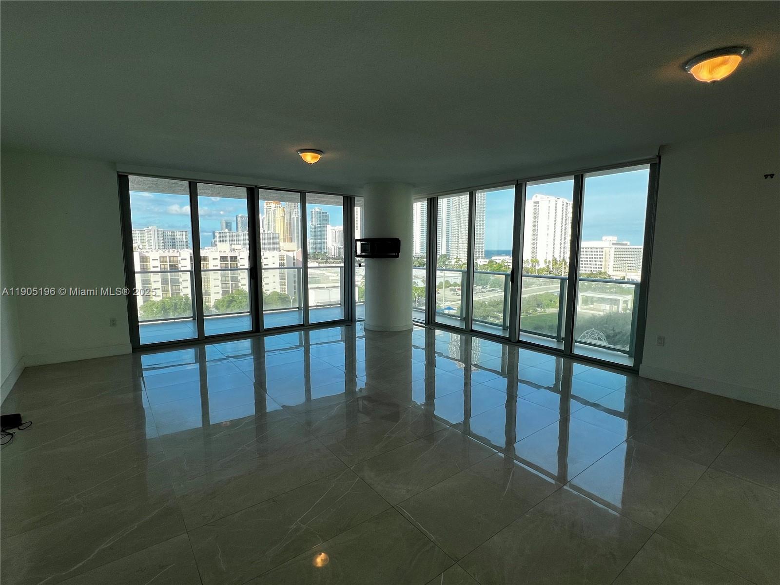 300 Sunny Isles Boulevard, Unit 4901 Sunny Isles Beach, FL 33160 - Photo 5 of 22 a view of empty room with large windows