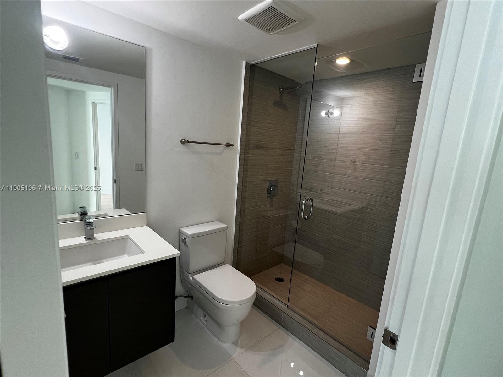 300 Sunny Isles Boulevard, Unit 4901 Sunny Isles Beach, FL 33160 - Photo 9 of 22 a bathroom with a sink a toilet and shower