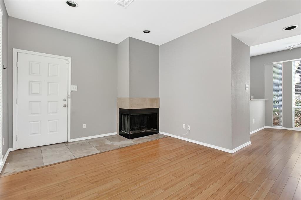 2002 North Fitzhugh Avenue, Unit 2 Dallas, TX 75204 - Photo 13 of 29 an empty room with wooden floor fireplace and windows