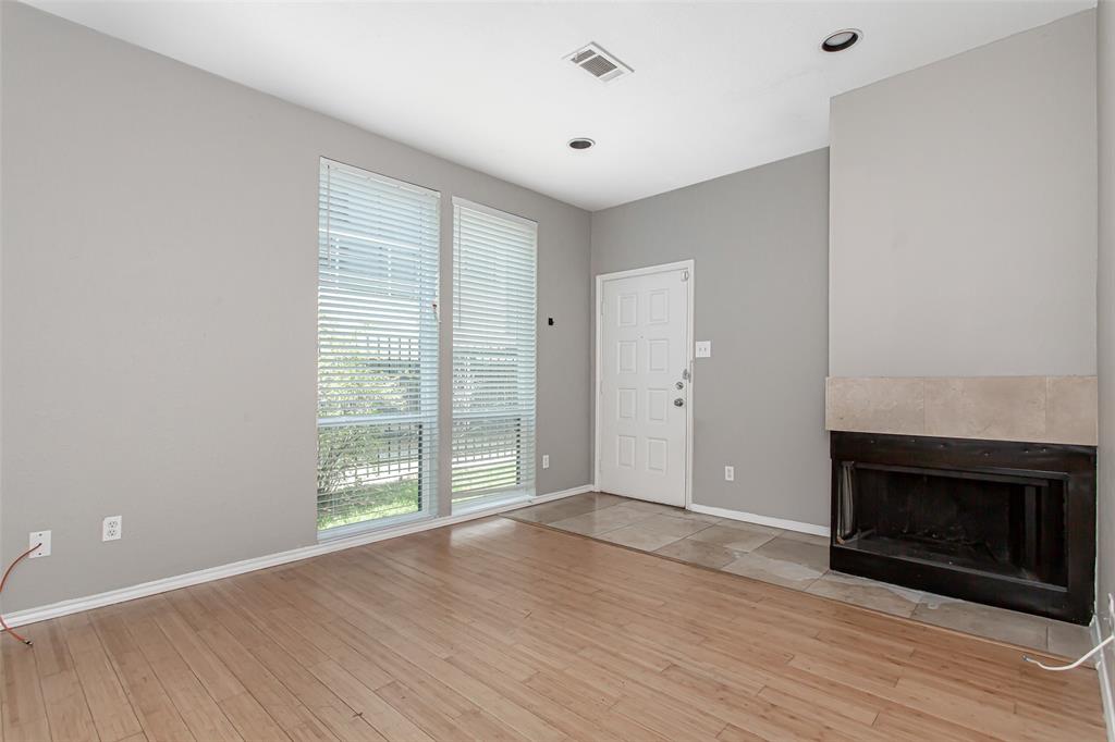 2002 North Fitzhugh Avenue, Unit 2 Dallas, TX 75204 - Photo 14 of 29 a view of an empty room with wooden floor fireplace and a window