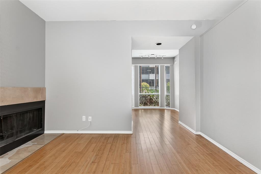 2002 North Fitzhugh Avenue, Unit 2 Dallas, TX 75204 - Photo 16 of 29 an empty room with wooden floor fireplace and windows