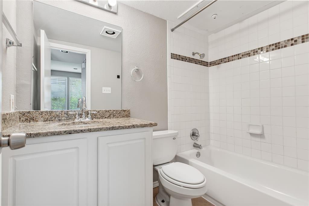 2002 North Fitzhugh Avenue, Unit 2 Dallas, TX 75204 - Photo 17 of 29 a bathroom with a granite countertop sink a toilet and a bathtub