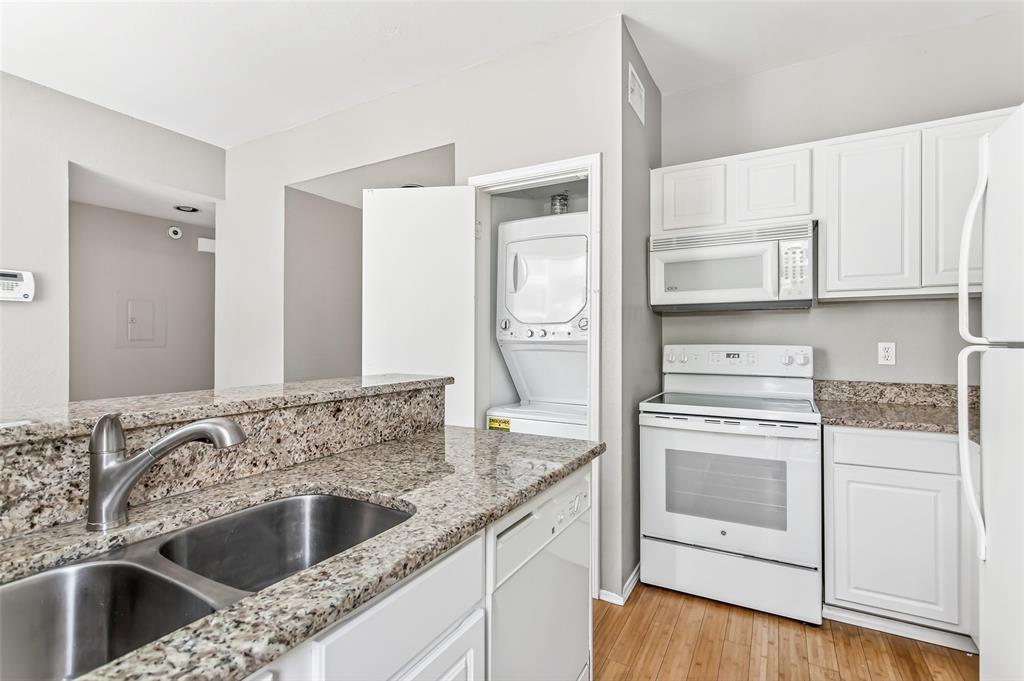 2002 North Fitzhugh Avenue, Unit 2 Dallas, TX 75204 - Photo 4 of 29 a kitchen with stainless steel appliances granite countertop a sink and a refrigerator