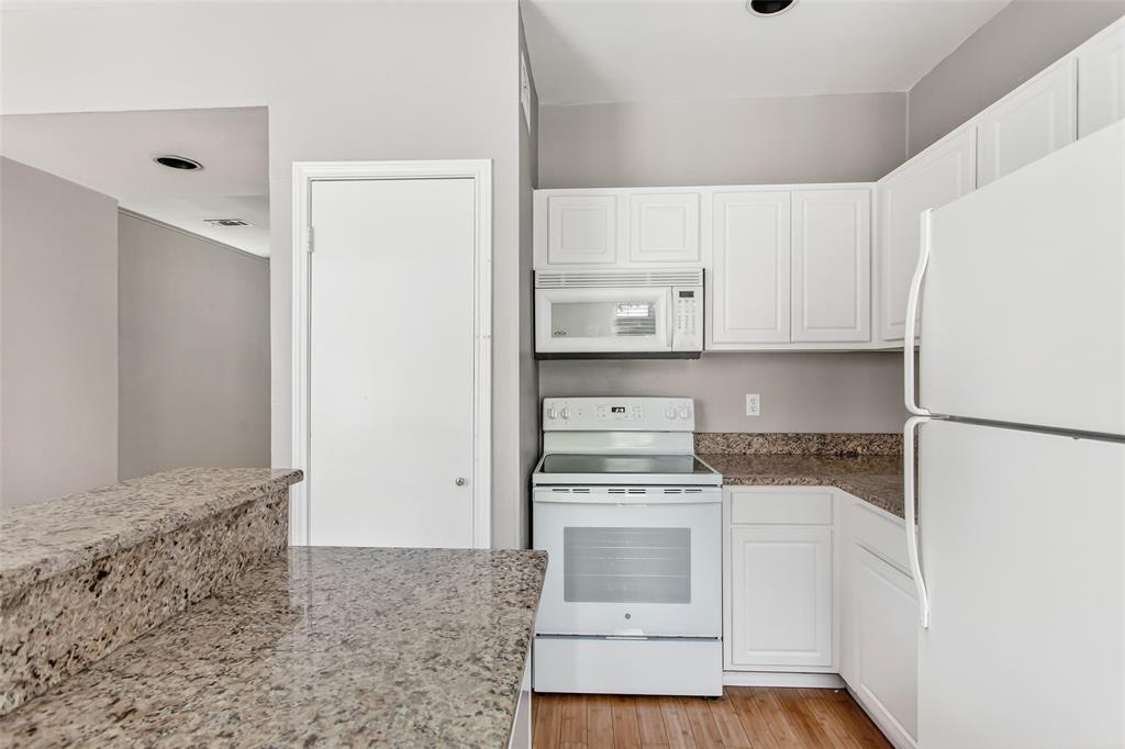 2002 North Fitzhugh Avenue, Unit 2 Dallas, TX 75204 - Photo 5 of 29 a kitchen with white cabinets and white appliances