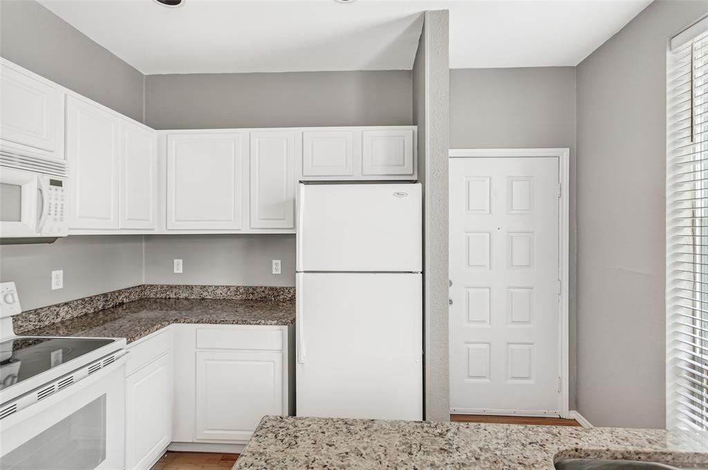 2002 North Fitzhugh Avenue, Unit 2 Dallas, TX 75204 - Photo 7 of 29 a kitchen with a refrigerator and white cabinets