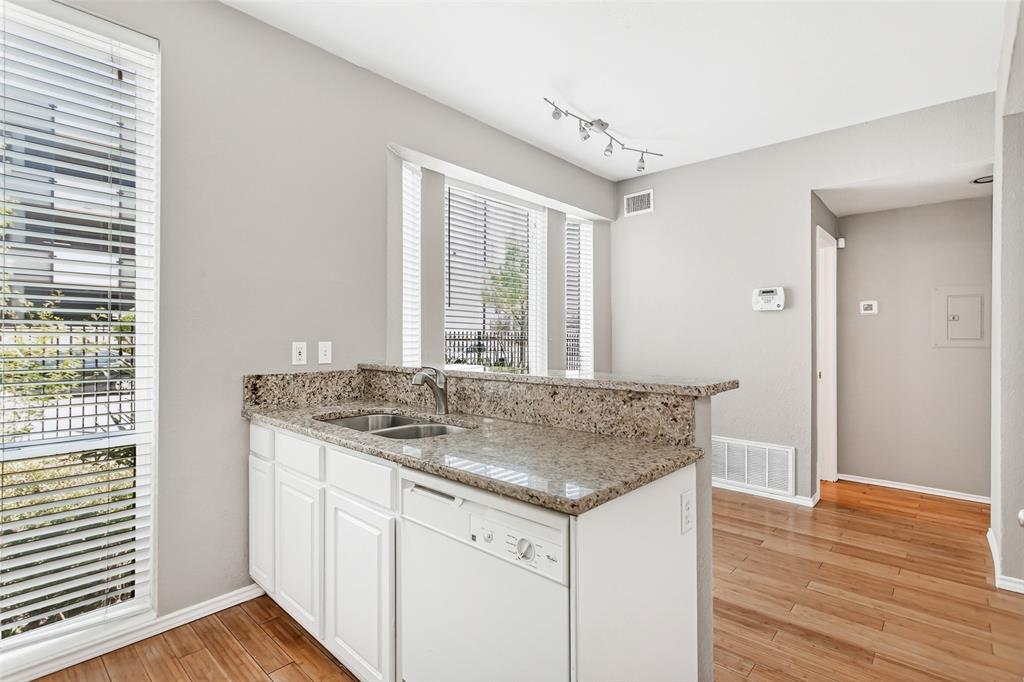 2002 North Fitzhugh Avenue, Unit 2 Dallas, TX 75204 - Photo 8 of 29 a room with kitchen island granite countertop wooden floor and a sink