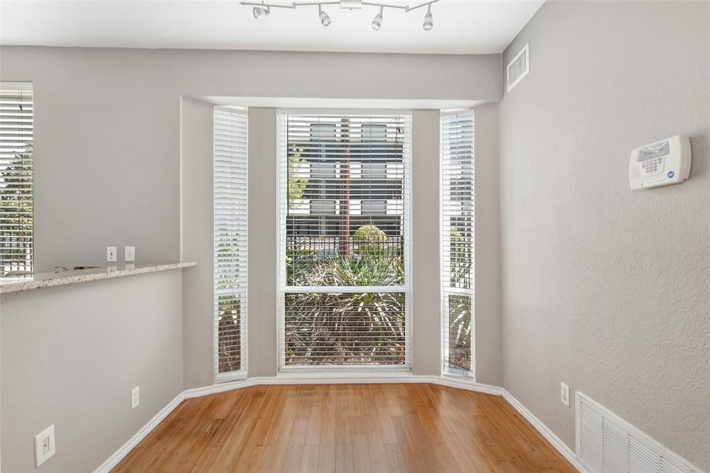 2002 North Fitzhugh Avenue, Unit 2 Dallas, TX 75204 - Photo 10 of 29 a view of an empty room with wooden floor and a window