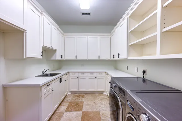 a kitchen with a sink and cabinets