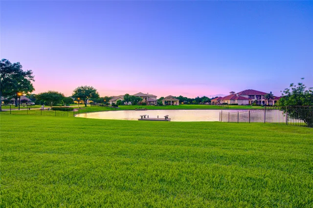 a front view of a house with swimming pool and sitting area