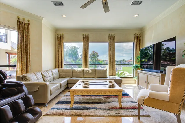 a living room with furniture and a floor to ceiling window