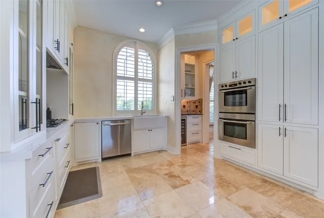 a kitchen with stainless steel appliances a refrigerator and a stove top oven