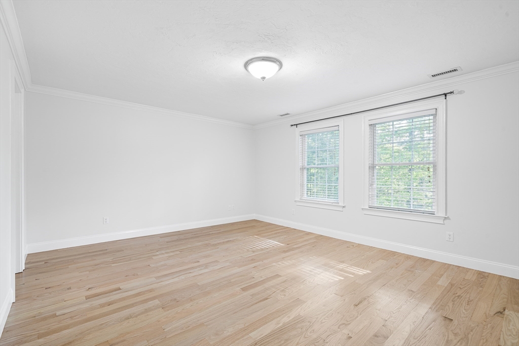 215 Rangeway Road, Unit 31 Billerica, MA 01862 - Photo 23 of 40 an empty room with wooden floor and windows