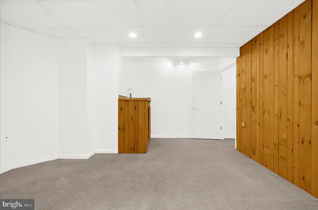 a view of staircase with railing and a rug