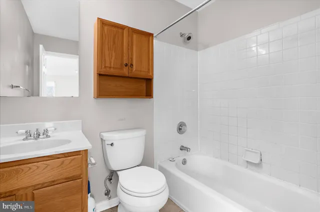 a view of a yard with plants and a large tree