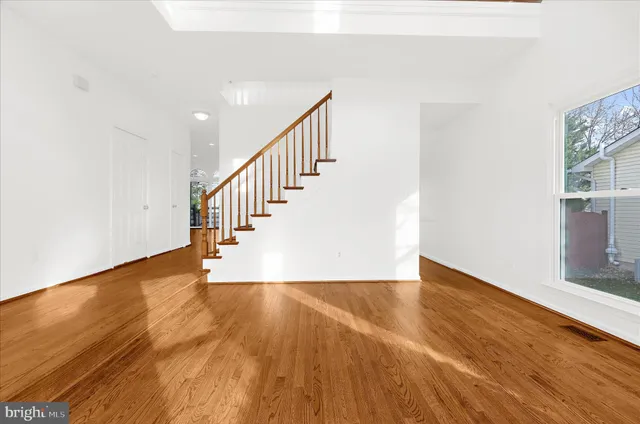 a view of entryway and hall with wooden floor