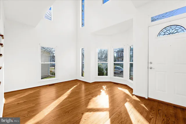 a view of a room with wooden floor and windows
